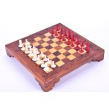 A small 19th or early 20th century Indian ivory chess set one side stained red, K4.9cm, with a later