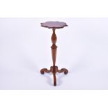 A 17th century style walnut tripod table the shaped top on a tapering turned and cut hexagonal stem,