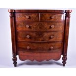 A large flame mahogany bow-front chest  with two short over three long drawers, flanked by faceted