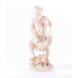 A highly detailed Japanese Meiji period carved ivory okimono in the form of an elderly fisherman,