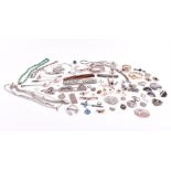 A group of silver and white metal items to include various items of jewellery, brooches,