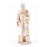 A Japanese Meiji period carved ivory okimono in the form of a robed figure pruning prunus