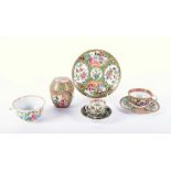 A collection of Chinese Cantonese famille rose porcelain comprising a plate, two cups and saucers, a