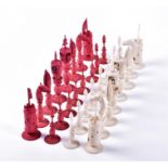 A 19th century Cantonese Macao pattern ivory chess set carved in white and red stained ivory, with