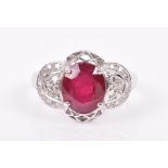 A fine ruby and diamond ring set with an oval mixed-cut natural ruby of approximately 2.48