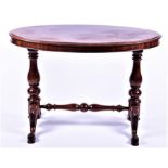 A Victorian style mahogany side table  of oval form, on turned baluster columns with four swept