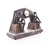 A large French Art Deco figural spelter lamp and clock the central enamel dial with roman