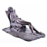 A Continental bronze study of a nude woman sat in a reclining position on a cabriole legged chair,