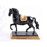 An early 20th century patinated bronze model of a horse realistically modelled in a trotting pose,