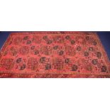 A large and impressive Uzbak hand-woven wool carpet circa 1950's, the deep red ground decorated with