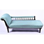 A Victorian style mahogany chaise longue upholstered in green foliate fabric, with scrolled end, and
