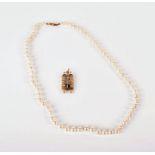 A 9ct yellow gold Torah pendant with opening doors, 7.5 grams, together with a pearl necklace with a