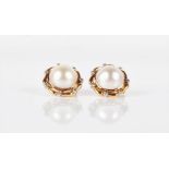 A pair of 18ct yellow gold, diamond, and pearl earrings of circular form, each set with a demi pearl