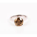 A yellow diamond ring set with a round brilliant-cut diamond of approximately 3.10 carats, set in