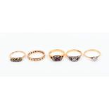 A group of five gold rings to include a yellow metal and solitaire diamond ring, size Q, two 18ct