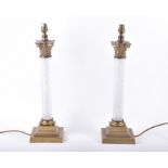 A tall pair of French brass mounted cut glass table lamps of Corinthian columnar style, the cut