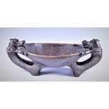 A large Dayak (Borneo) ironwood and rattan Chieftain's bowl the central bows  flanked by a pair of