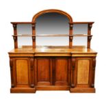 A 19th century Continental oak mirror back sideboard with arched top, the base with two central
