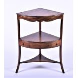 An Edwardian mahogany floor standing corner washstand the bow fronted top opening to reveal the