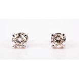 A fine pair of solitaire diamond ear studs set with round brilliant-cut diamonds of approximately