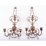 A pair of 20th century soft metal wall lights holding twin lights, designed with harebell floral