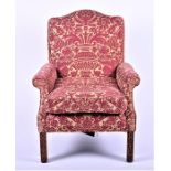 A Georgian style upholstered wing armchair with blind fret carved mahogany front legs, 74 cm wide.