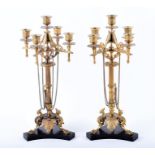 A pair of 19th century ormolu candelabra in the Barbedienne style with winged griffins and