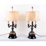 A pair of late 19th century gilt and patinated bronze lamps holding three lights, designed with