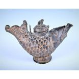 An Eastern bronze water vessel in the form of a fish with a looping handle and finial lid