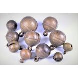 A collection of eleven old Asian brass spherical bells believed to be Tibetan, all with incised