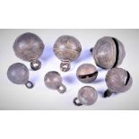 A collection of eight various old Asian brass and bronze 'tiger' or spherical bells believed to be