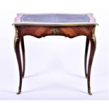 A small Louis XV style reproduction writing table with gilt and tooled leather top, above a single