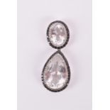 An 18ct white gold, black diamond and gemstone pendant set with an oval faceted gem (possibly