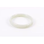 A Chinese hardstone bangle pale green, internal diameter 6.5 cm.