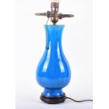 A late 19th century blue glazed earthenware lamp in the Burmantofts style, later converted to a lamp