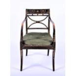 An ebonised Regency armchair with gilt painted decoration and cane seat, on front cabriole legs,