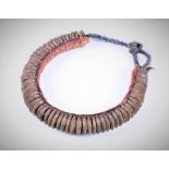 An old African banded brass necklace composed from 64 tapering bladed and incised brass rings,