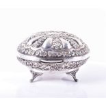 A small Egyptian silver box Cairo, 20th century, the box of oval form, with floral repoussé