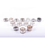 A collection of assorted silver napkin rings Including two singular boxed napkin rings and twelve