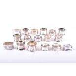 A collection of assorted silver napkin rings  Some with engraved initials and engine turned