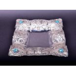 A contemporary silver embossed tray with shell, flower and leaf decoration, set with blue paste