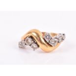 An 18ct yellow gold and diamond crossover style ring set with eight round-cut diamonds of