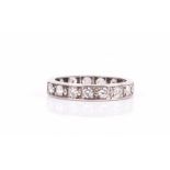 A diamond eternity ring set with seventeen round-cut diamonds of approximately 0.80 carats combined,