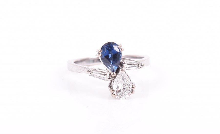 An unusual 18ct white gold, diamond, and sapphire ring in the Toi et Moi style, set with a pear-