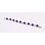 A lapis lazuli and pearl bracelet of alternated beads, fastened with an 18ct yellow gold and