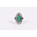 A diamond, emerald, and sapphire cocktail ring centred with an elongated oval mixed-cut emerald, the