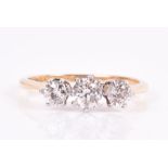 An 18ct yellow gold and diamond ring set with a larger round-cut diamond flanked with two smaller,