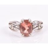 A 9ct white gold, diamond, and Tibetan sunstone ring the Art Nouveau style mount set with an oval-