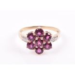 A 9ct yellow gold, diamond, and rhodalite garnet floral cluster ring set with seven round-cut