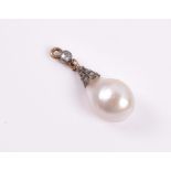 A natural pearl pendant the drilled pearl approximately 10.5 mm long, the metal mount inset with